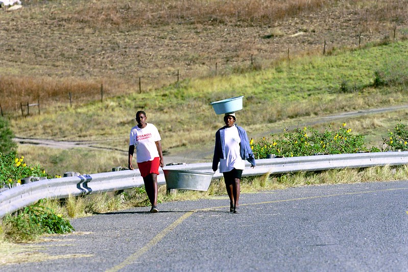 Two girls carry buckets in South Africa