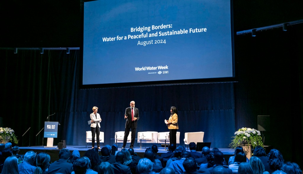 In the picture, there are three people giving speeches at the stage at Stockholm Water Week 2023.