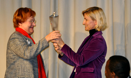 President Tarja Halonen accepts the Torch from Danish Minister for Development Cooperation Ulla Tørnæs. Photograph: Kari Rissa