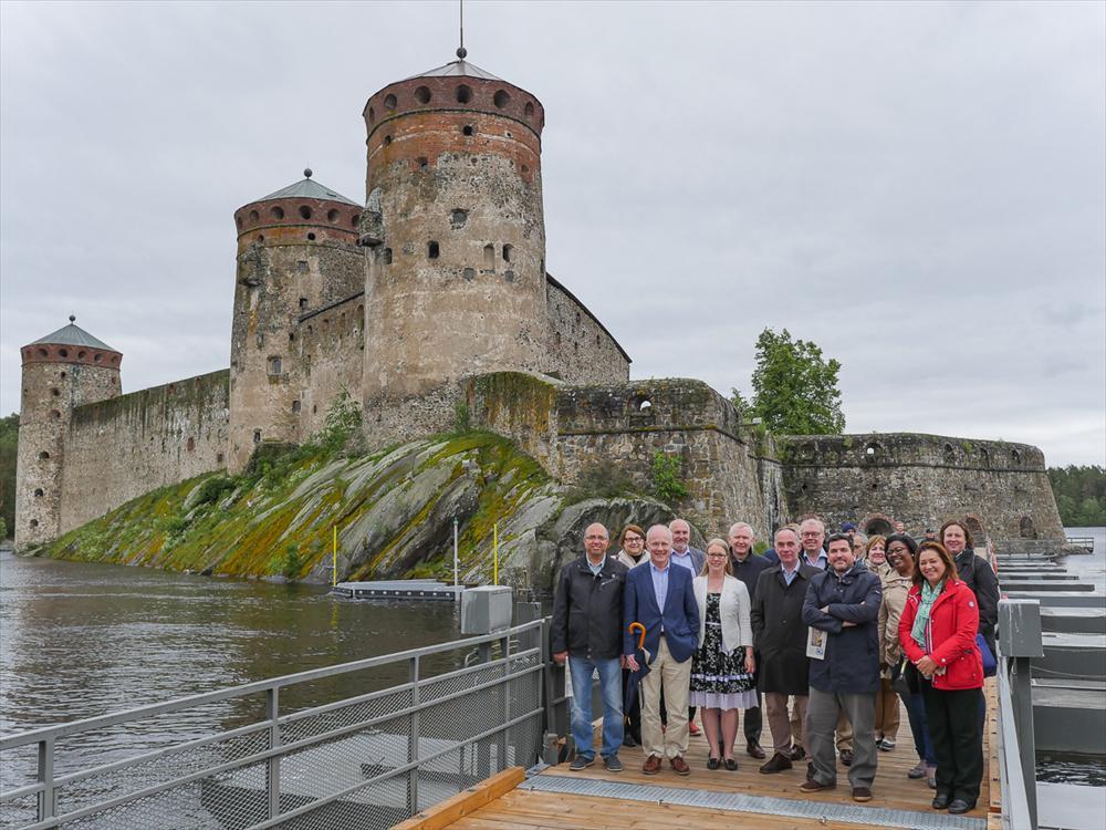 The Ambassadors in front of the medieval castle in Savonlinna with Ms Anna-Kristiina Mikkonen, Chair of the Regional Council of Savonlinna.